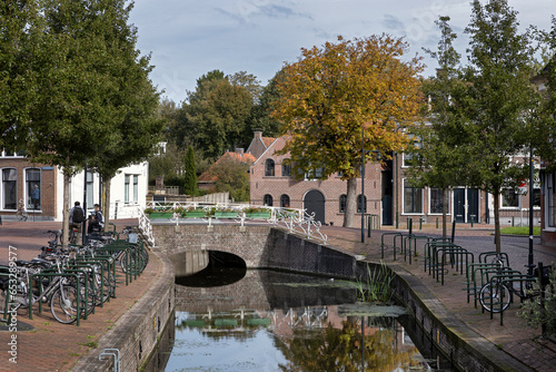 Street and canal at Dokkum. Friesland Netherlands. Stone bridge.  © A