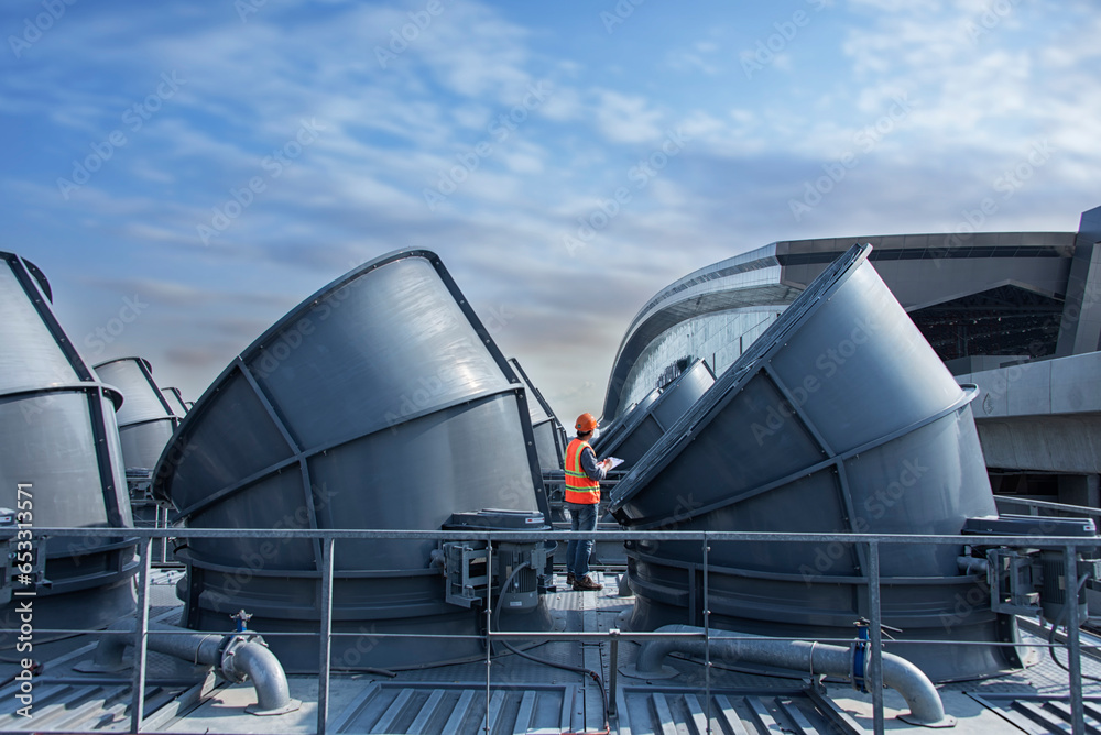 worker open valve of cooling tower on blue sky background. worker
