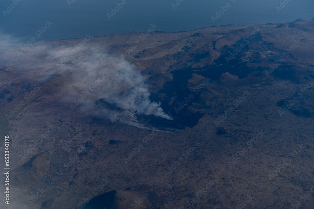 A burning volcano from an airplane window. Iceland.