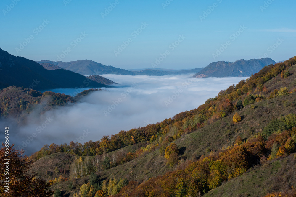 Morning mist in the mountains in a sunny autumn day