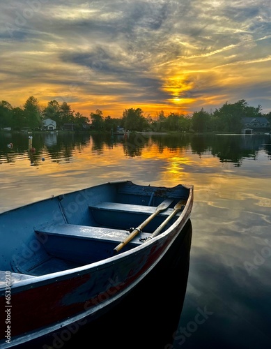 Rowboat on tranquil lake at Sunset