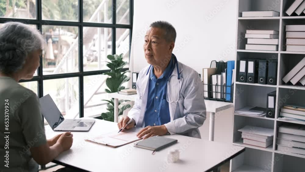 Senior male doctor with female patient hospital. Doctor and patient discussing something while sitting in hospital room. Medicine and healthcare concept Senior male doctor with female patient hospital. Doctor and patient discussing something while sitting in hospital room. Medicine and healthcare concept