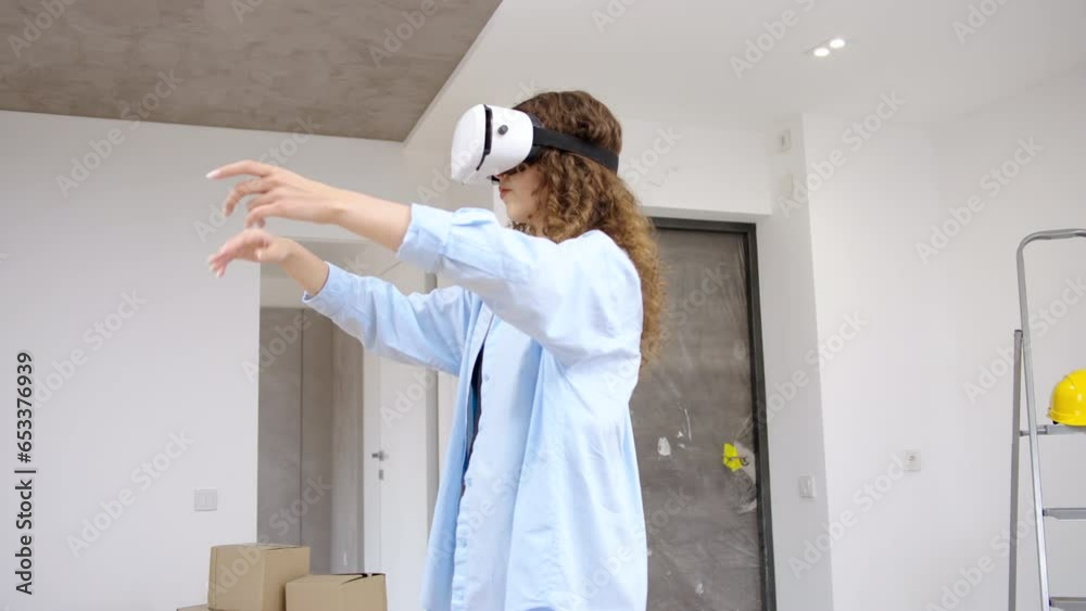 Young modern caucasian female wearing VR headset using augmented reality technologies to redesign apartment