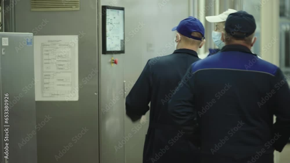 Service Of Equipment. Technical Specialists Gathered To Check Industrial Machine At Factory. Industrial Machine Service. Explaining How To Work With Industrial Machine. Production Service.