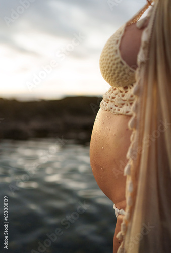 Pregnant woman in profile close-up.