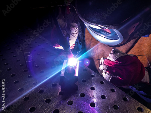 Фотография Welder is welding Tungsten Inert Gas welding, TIG weld for making new stainless