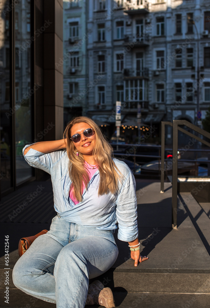 Fototapeta premium Plus size European or American nice woman at city, enjoy the life, walks. Life of people xl size, happy nice natural beauty woman. Concept of overweight