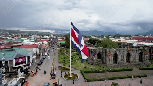 Beautiful View of the Costa Rica Flag with the Bicentennial Angel in Cartago, next to the Ruins and the basilica - Costa Rica Patriotic Symbols