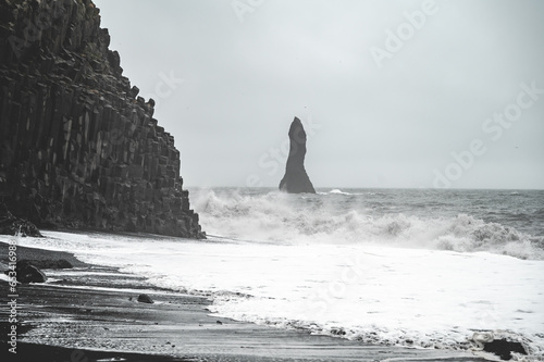 Rock sculpture with heavy waves at Black Sand Beach Reynisfjara, Iceland © Bildgigant