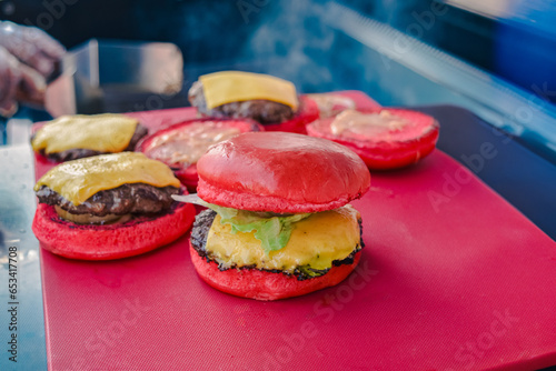 red burger with blur burger background and smoke (ID: 653417708)
