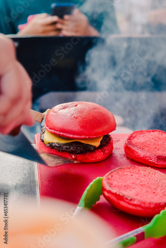 red burger on a saucer with smoke background (ID: 653417781)
