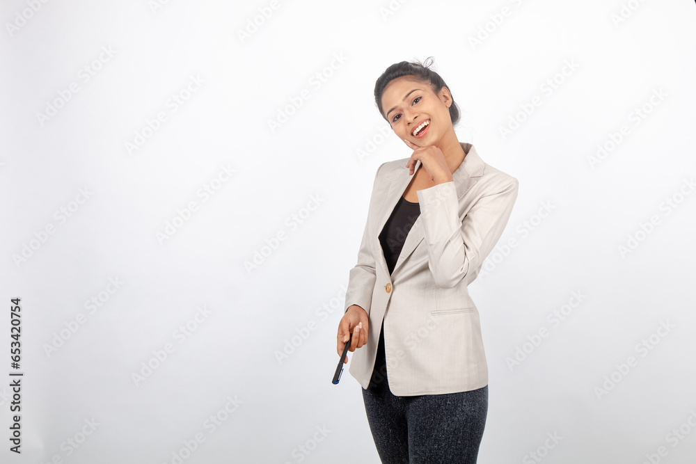 Corporate office lady with black hair having playful moment with pen in formal wear wearing white blazer against white background. Corporate office lady with black hair having playful moment with pen in formal wear wearing white blazer against white background.