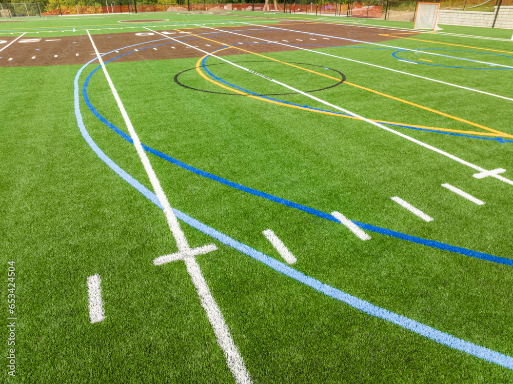 Obraz premium New synthetic turf field with football and baseball with lines and graphics.