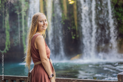 Beautiful woman with long hair on the background of Duden waterfall in Antalya. Famous places of Turkey. Apper Duden Falls photo