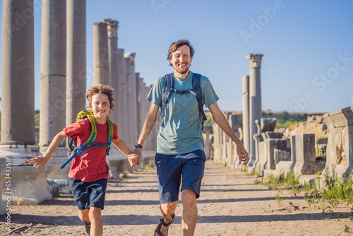 dad and son tourists at the ruins of ancient city of Perge near Antalya Turkey. Traveling with kids concept