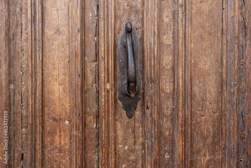Old wooden door with black painted metal knocker