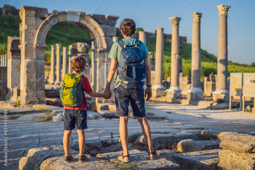 Fototapeta premium dad and son tourists at the ruins of ancient city of Perge near Antalya Turkey. Traveling with kids concept