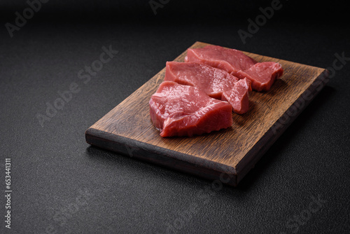 Raw fillet steak mignon beef with salt, spices and herbs