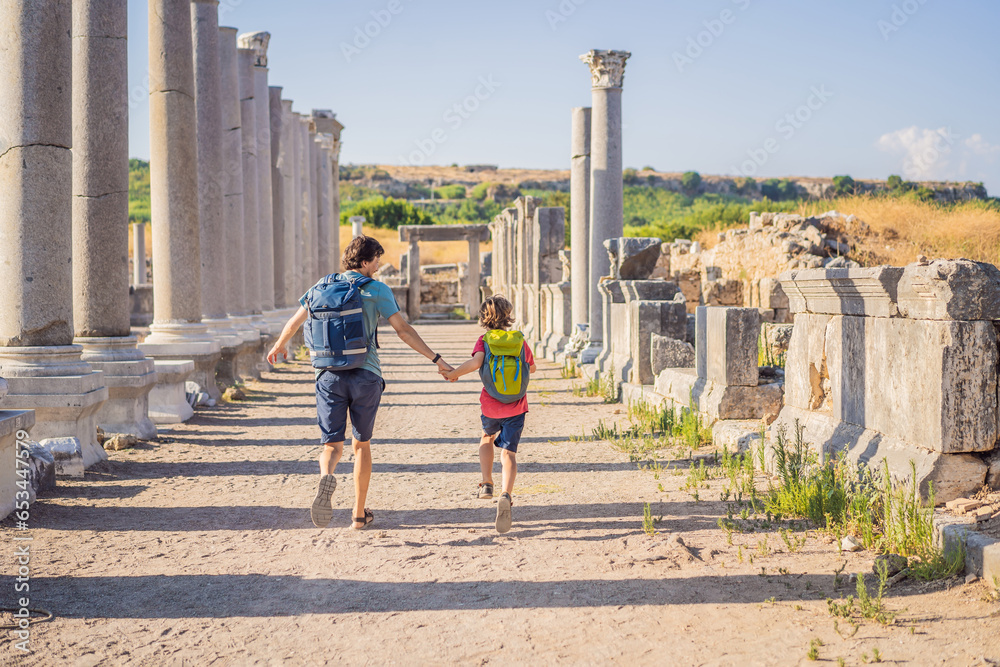 dad and son tourists at the ruins of ancient city of Perge near Antalya Turkey. Traveling with kids concept - obrazy, fototapety, plakaty 