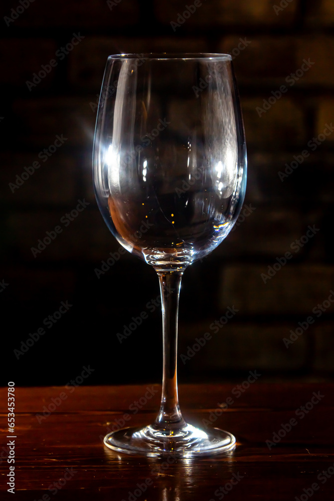 Empty glass with reflections on dark background Empty glass with reflections on dark background