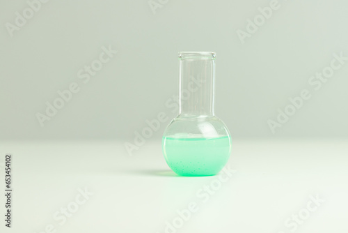 Chemical vials with green liquid on white background, chemical research, chemist set