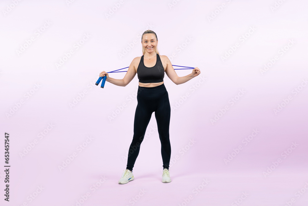 Full body length shot athletic and sporty senior woman with fitness exercising rope on isolated background. Healthy active physique and body care lifestyle senior people. Clout