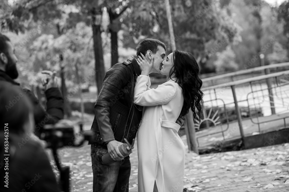 A man hugs a pregnant woman. A man uses a fire extinguisher to determine the sex of his child. Gender party. Happy parents A man hugs a pregnant woman. A man uses a fire extinguisher to determine the sex of his child. Gender party. Happy parents