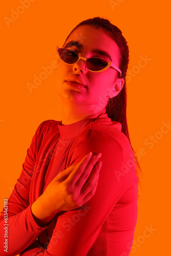 Fashionable young woman wea...
