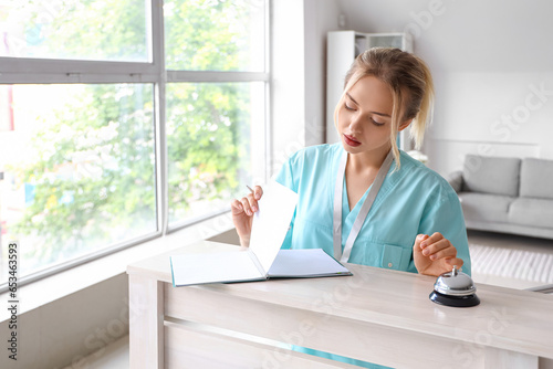 Female medical intern writi...