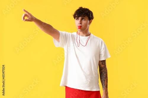 Male lifeguard with whistle...