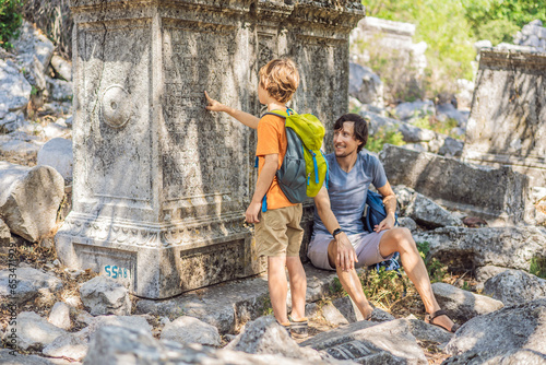 Father and son tourists explores Stunning Ancient Theater of Termessos Ancient City. Traveling with kids concept. turkiye, GO Everywhere