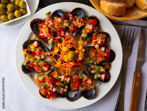 Stuffed by vinaigrette from vegetables tasty mussels at plate on table photo