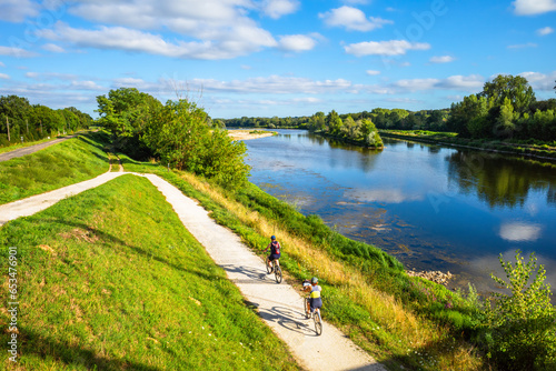 Chatilllon sur Loire, France - August 9, 2023: Cyclists ride on thefra cycle path along the Loire River in France. photo