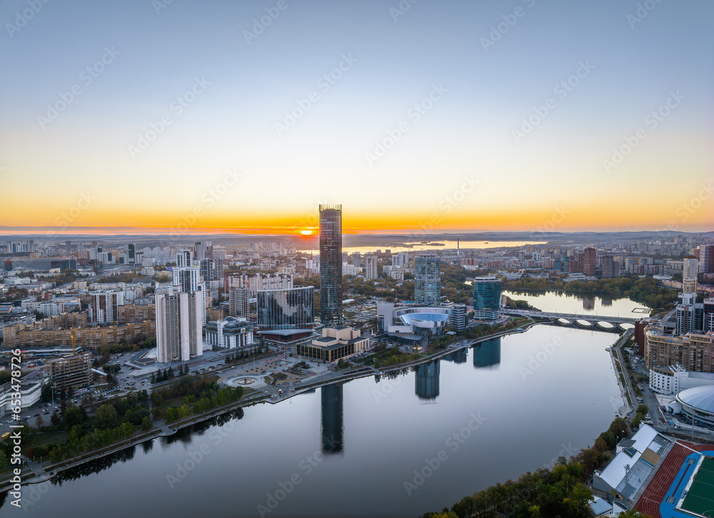 Yekaterinburg city and pond aerial panoramic view at summer or early autumn sunset. Night city in the early autumn or summer.