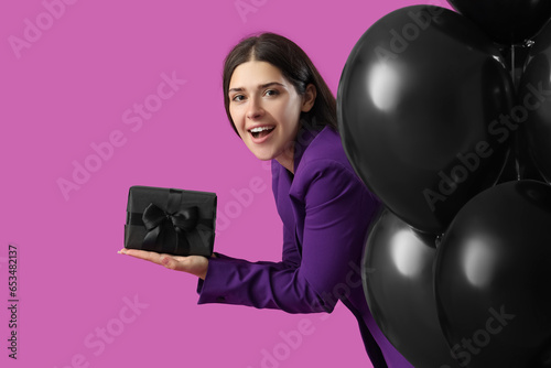 Young woman with gift box a...