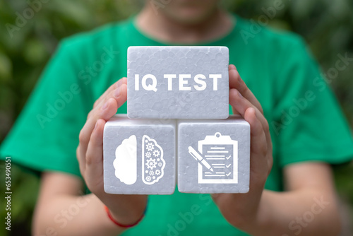 Photos Little girl holding white foam blocks sees inscription: IQ TEST