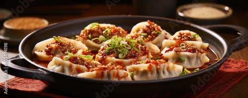 Unleash your taste buds on these fiery dumplings, their vibrant red chiliinfused dough housing a fiery filling of ground pork, tonguetingling Szechuan peppercorns, and aromatic Chinese fivee photo