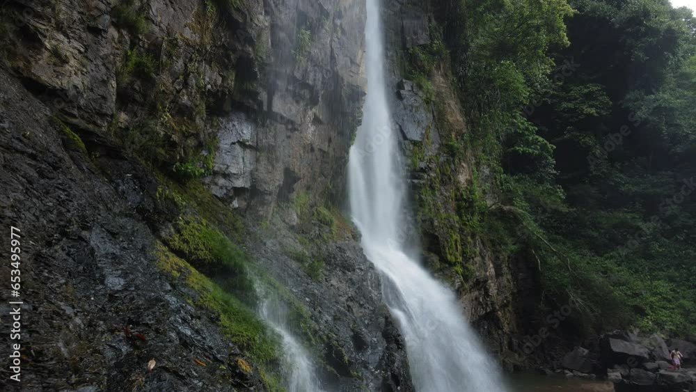 Drone shot of the famous Nauyaca Waterfall in Costa Rica. Misty day in the Central American tropical rainforest. Drone shot of the famous Nauyaca Waterfall in Costa Rica. Misty day in the Central American tropical rainforest.