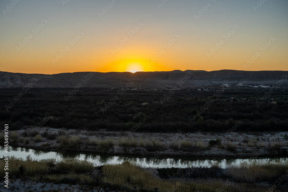 Sun Sets Below the Horizon over The Narrow Rio Grande