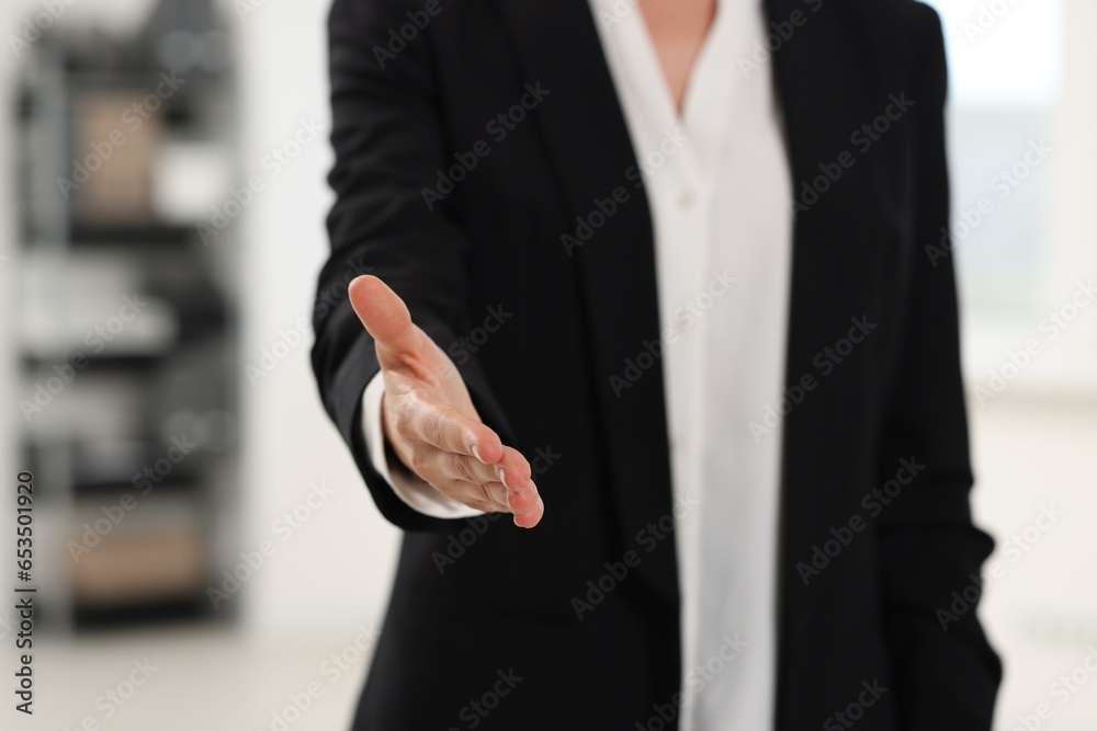 Fototapeta premium Woman welcoming and offering handshake indoors, closeup