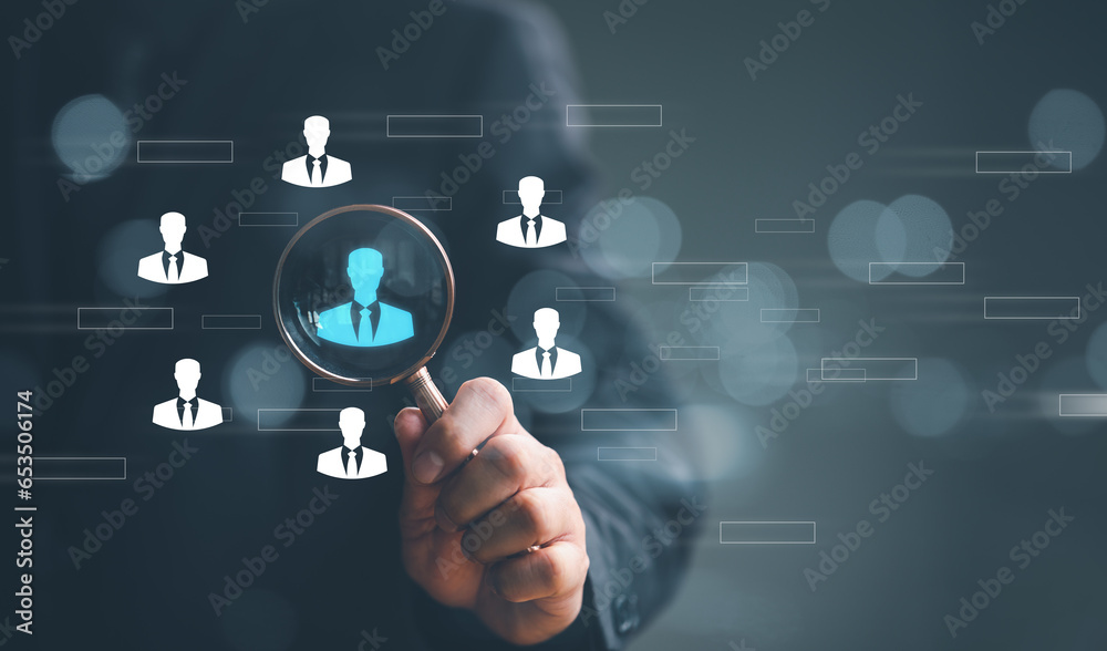 Naklejka premium Human Resource Management HRM concept. Businessman holding magnifier for searching to human icons for human development and recruitment concept.