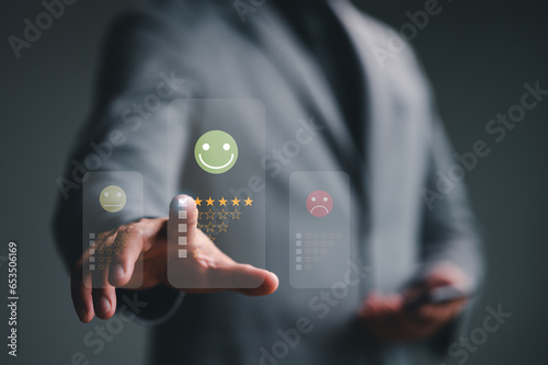 Businessmen choosing on the happy Smile face icon to give satisfaction in service, Customer service and Satisfaction concept, rating very impressed. review, feedback, best quality, good mood.