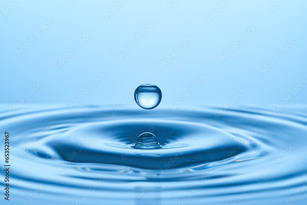 Group of water droplets fall and bounce on a water surface Group of water droplets fall and bounce on a water surface
