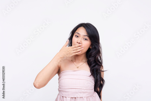 A young asian woman gaps while looking at the camera looking shocked. Isolated on a white background. © Mdv Edwards