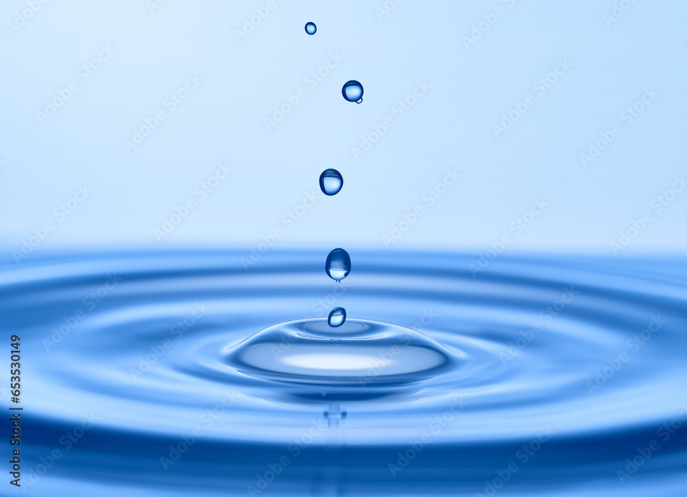 Group of water droplets fall and bounce on a water surface Group of water droplets fall and bounce on a water surface