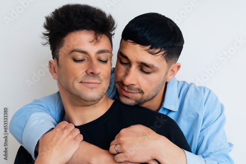 Gay men couple hugging each other photo