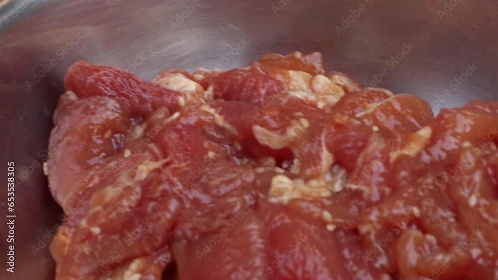 The cube of the fat is dissolve in a hot pan with a raw meat ready for grilling The cube of the fat is dissolve in a hot pan with a raw meat ready for grilling