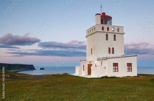 Dyrhólaey lighthouse, located near Vik and on the south central coast of Iceland, at sunset  © Claudia