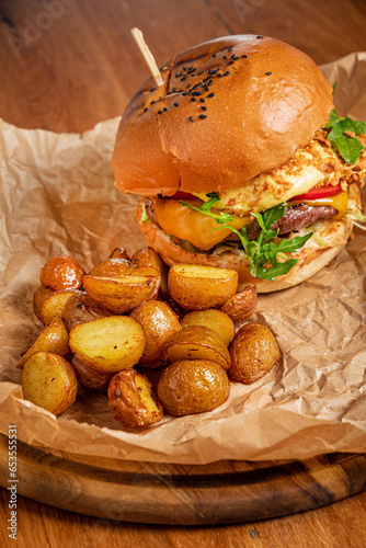 burger with baked potato on parchment