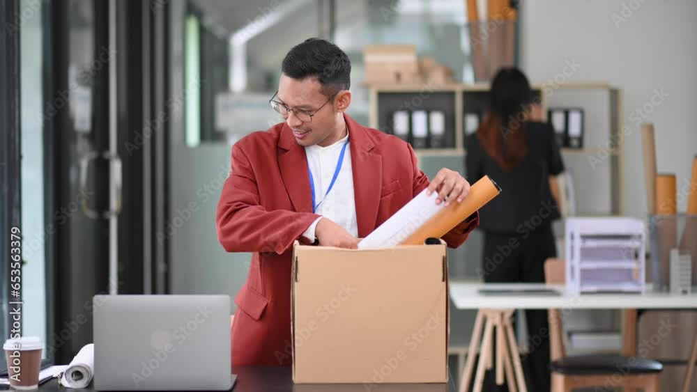 Happy and excited young Asian man office worker celebrating her resignation, carrying her personal stuff. leaving job, changing or company. in office Happy and excited young Asian man office worker celebrating her resignation, carrying her personal stuff. leaving job, changing or company. in office